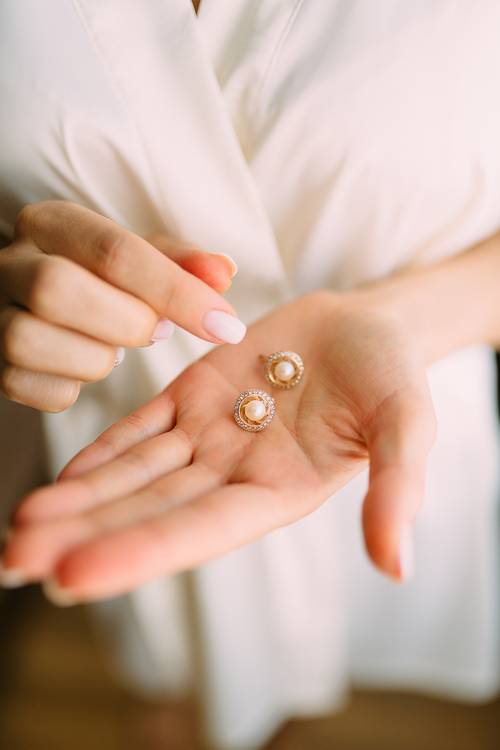 pearl earrings with diamond stud circles around them