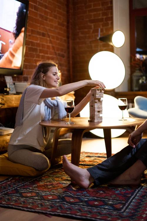 woman playing board games Jenga