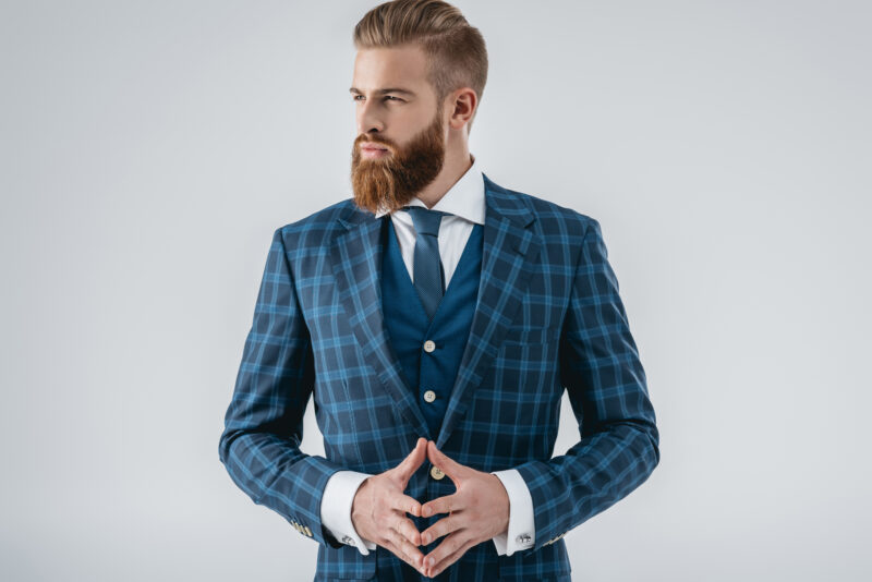 male model in blue plaid jacket and brilliant beard