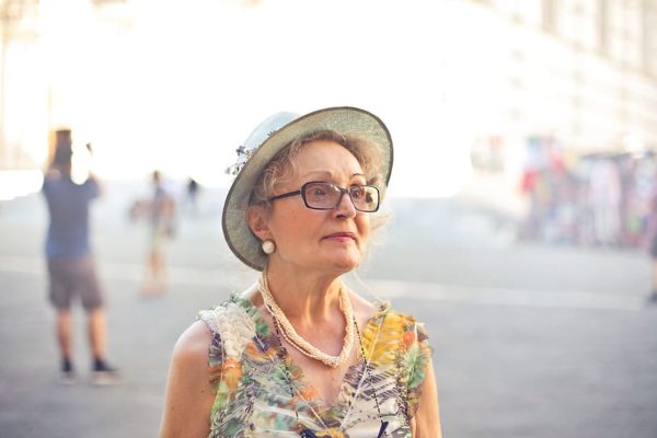 aging woman with hat and glasses